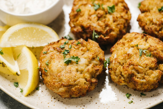 Homemade crab cakes on a plate with lemon