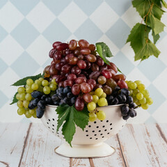 grapes in a colander on a light background
