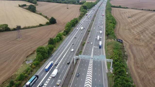 Aerial View of British Motorways With Fast Moving Traffic at Peak Time. M1 J11 and  J7 Motorways Junction Interchange. Time Lapse Shot captured on 7th Sep 2022