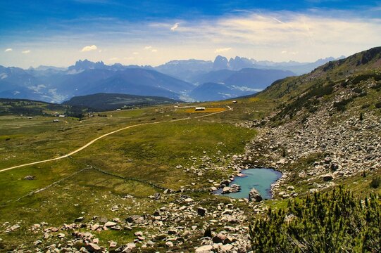 Aerial view of a beautiful lake near the mountains in Villanders, Italy