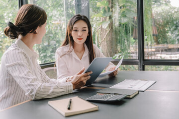 Marketer or analytic manager team dressed in suits working with paper charts and laptops at the meeting room.