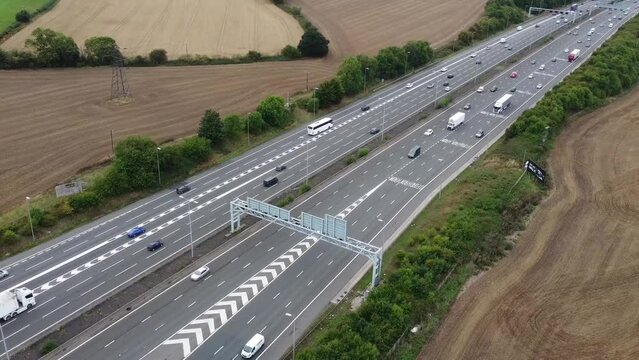 Aerial View of British Motorways With Fast Moving Traffic at Peak Time. M1 J11 and  J7 Motorways Junction Interchange. Time Lapse Shot captured on 7th Sep 2022