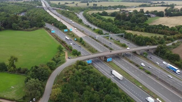 Aerial View of British Motorways With Fast Moving Traffic at Peak Time. M1 J11 and  J7 Motorways Junction Interchange. Time Lapse Shot captured on 7th Sep 2022