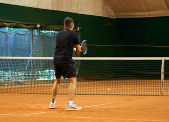 athlete trains on the court to play tennis