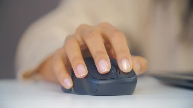 Black woman clicking with wireless computer mouse while working on laptop. African entrepreneur person use mouse manipulator device in 4k stock video
