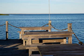 wooden tables on the pier - 529251476