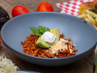 dry pasta with tomato sauce, avocado and cheese
