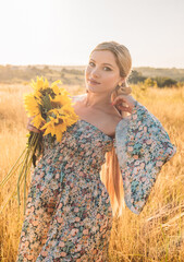 portrait of beautiful happy pregnant woman in countryside during sunset