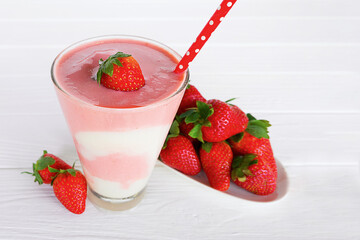 Strawberry yogurt fruit juice smoothie pink colorful fruit juice milkshake blend beverage healthy high protein the taste yummy In glass drink episode morning on white wood background.