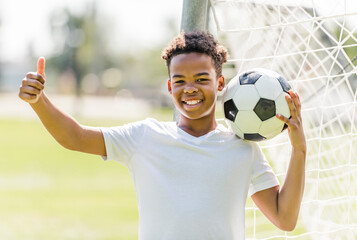 happy multicultural hispanic soccer player outdoor in sunny day