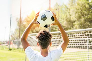 happy multicultural hispanic soccer player outdoor in sunny day