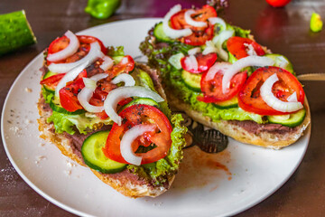 Sandwich bread sandwich baguette vegetables cucumbers tomatoes garlic onions lettuce.