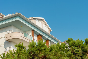 Image of the exterior of a residential building against a blue sky.