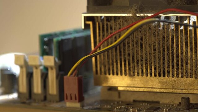 Very dirty CPU heatsink on the motherboard. Close-up.