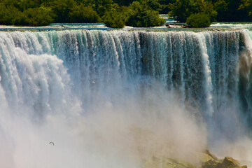 Water flowing over the Bridal Veil Falls and mist rising from the rocks below