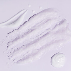 Sample beauty products for facial skin care on pink background. Cleanser foam, tonic, oil serum essence drop and moisturizer cream smear