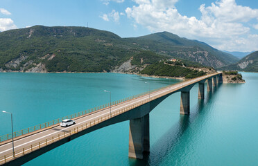 Aerial view of bridge, lake and mountains in Central Greece, Evrytania region. Lake Kremaston. - Powered by Adobe