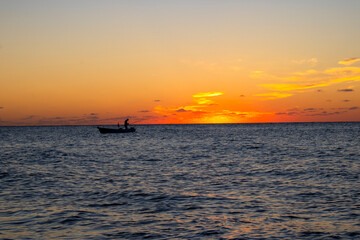 Naklejka na ściany i meble Sunset and fishing boats. setting sun