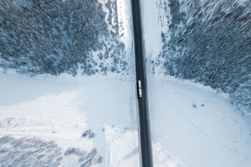 aerial view of a truck driving over a bridge over a river