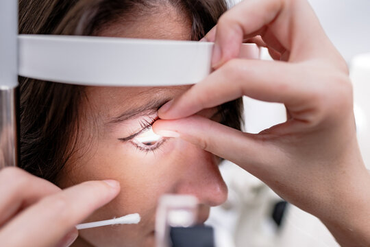 Crop doctor and patient in clinic with optical tonometer