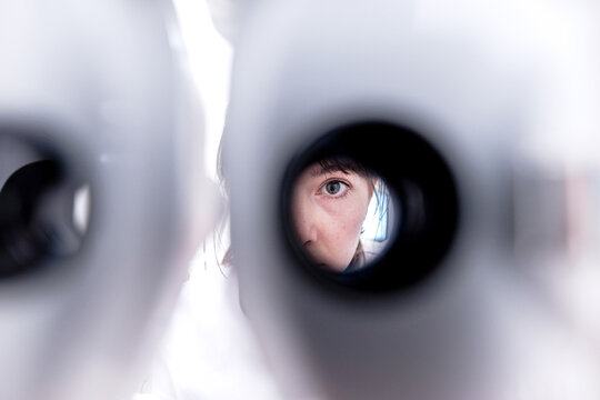 View of doctor through phoropter in clinic