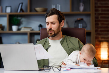 Father on maternity leave, holding an online conference, a meeting in the home office with a small child in his arms. Dad with a child. Freelancer combines child care and work. Paternity leave