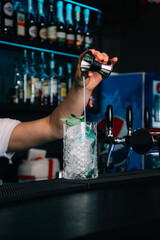 bartender pouring beer into glass