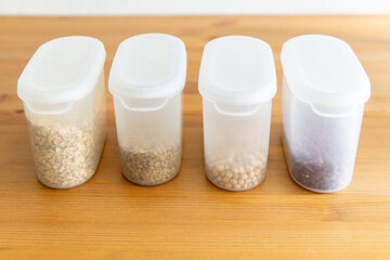 containers with cereals on a wooden table.