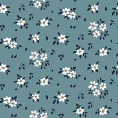 Fototapeta premium Seamless floral pattern, romantic ditsy print with small white flowers on a blue surface. Pretty botanical background design with tiny drawing plants: flowers, leaves. Vector illustration.