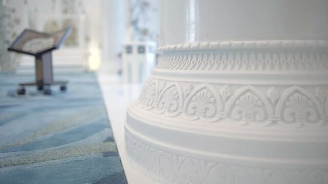 Interior of a white orthodox beautiful church. Scene. Close up view of the column with carved pattern.