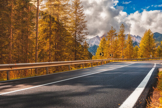 Beautiful landscape with roadway. Highway in mountains in autumn day in Italy, empty asphalt road. Dolomites, Alps