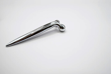 Modern metal face roller on white background, top view