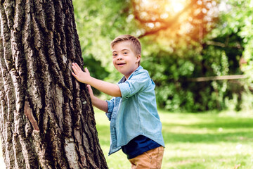 Portrait of a little boy with down syndrome while playing in a park