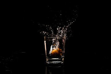 High resolution natural water splash freeze motion from a clean glass of water with droplet and bubble formation