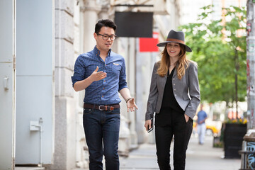Business people walking on sidewalk in city