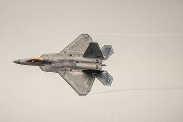Low angle view of fighter plane flying in sky