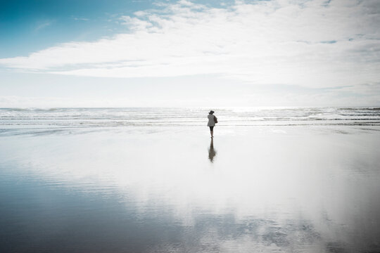 Rear View Of Woman Walking At Beach