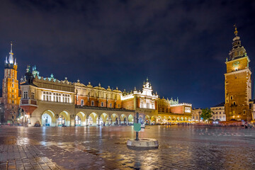 Fototapeta na wymiar Krakow city in the evening in Poland, Main Square in the Old Town, illuminated St. Mary Church and Cloth Hall (Sukiennice).