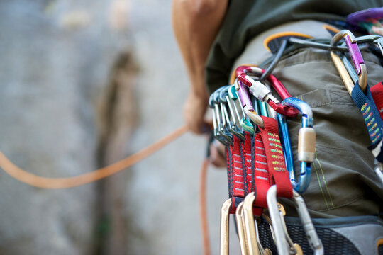 Midsection of man with climbing equipment