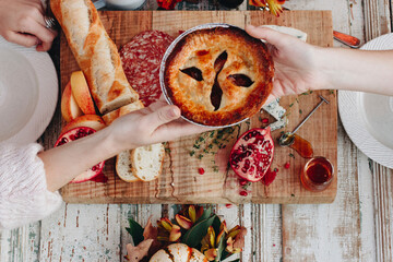 Overhead view of friends holding pie container