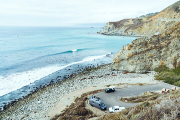 High angle view vehicles on winding road against sea