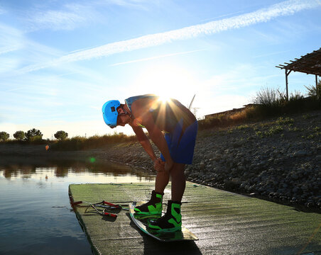 Side view of man with kiteboard standing on pier