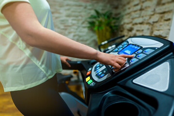 Woman jogging on treadmill at the home gym.