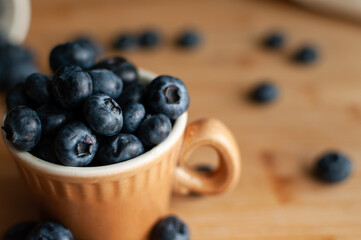 Fresh blueberries in terracotta cup. Close up.. Top view. Selective focus.