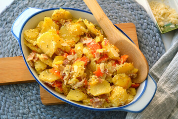 Baked potatoes and sweet potatoes with cream and bacon