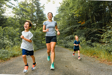 mother and sons running outside in forest