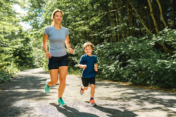 mother and son running outside in forest