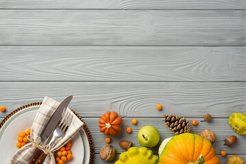 Thanksgiving day concept. Top view photo of plate knife fork napkin raw vegetables pumpkins pear...