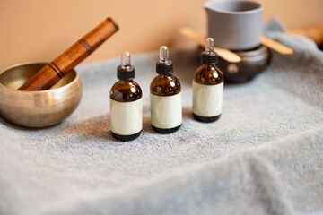 Obraz na płótnie Canvas Essential oil for massage in jars and other props for massage on a towel