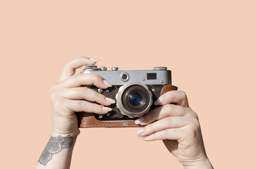 Female hands holding vintage film camera	